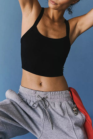 Black ribbed active tank top with a curved hem and thin straps.