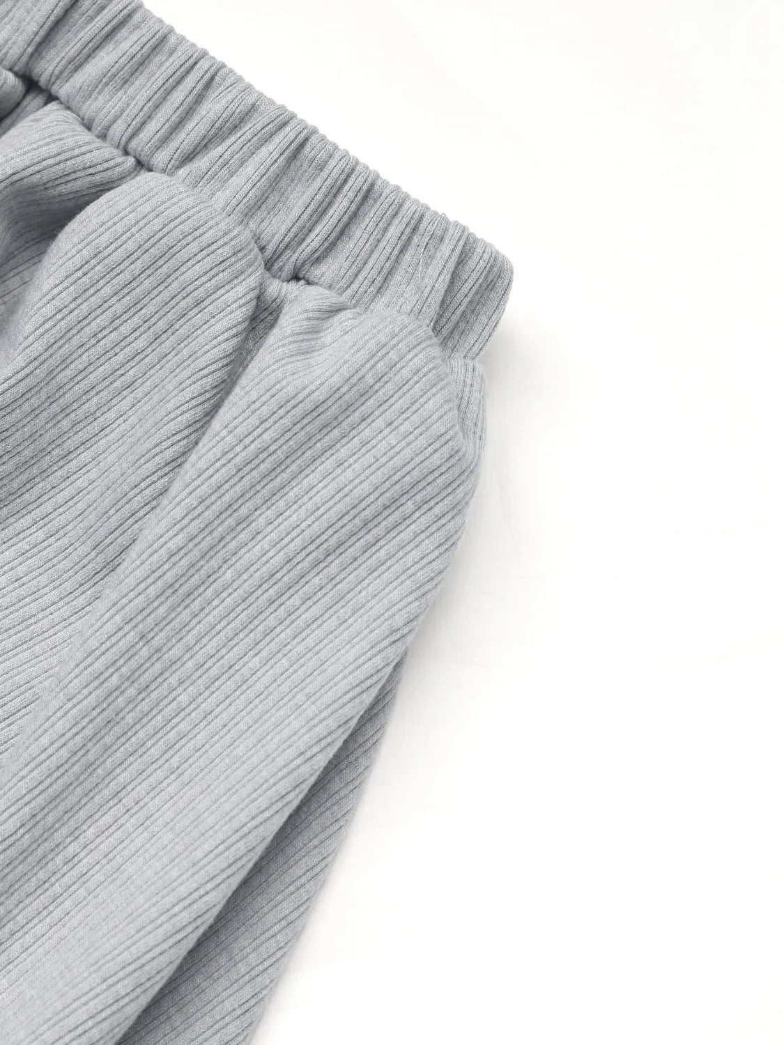Gray ribbed knit co-ord set detail showing elastic waistband and gathered fabric.