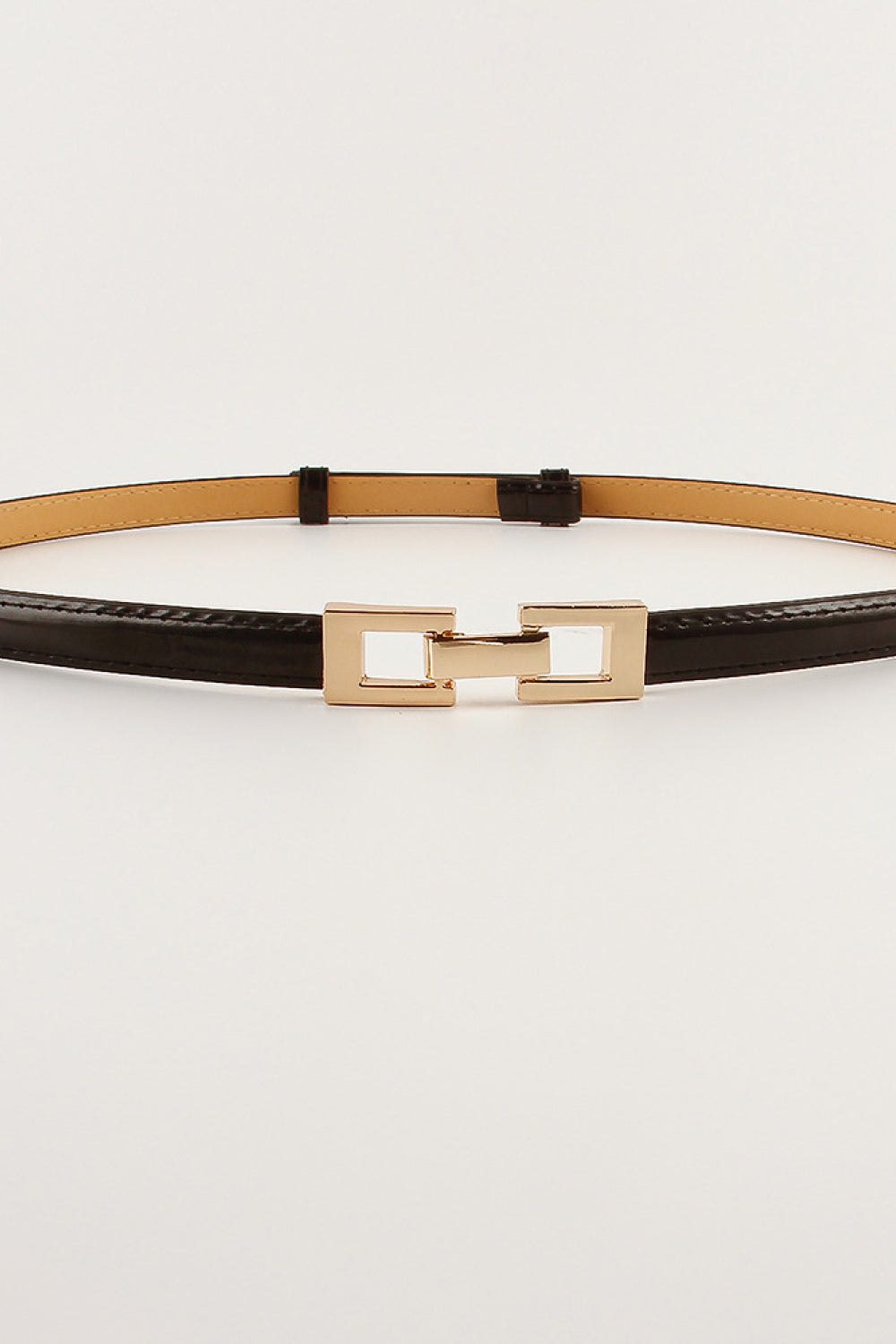 Black leather belt with gold geometric buckle detail