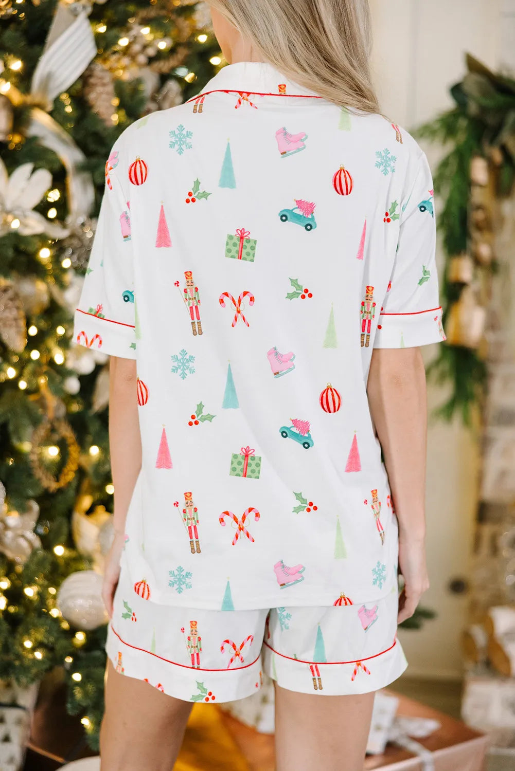 White cotton pajama set with festive holiday print and contrast piping.