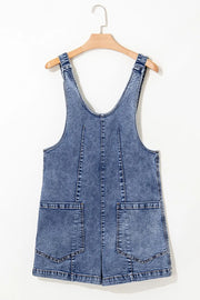 Acid wash denim romper with patch pockets and a V-neck.