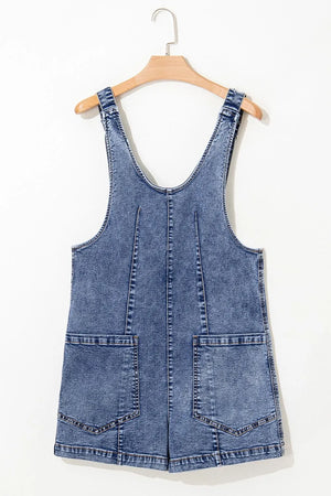 Acid wash denim romper with patch pockets and a V-neck.