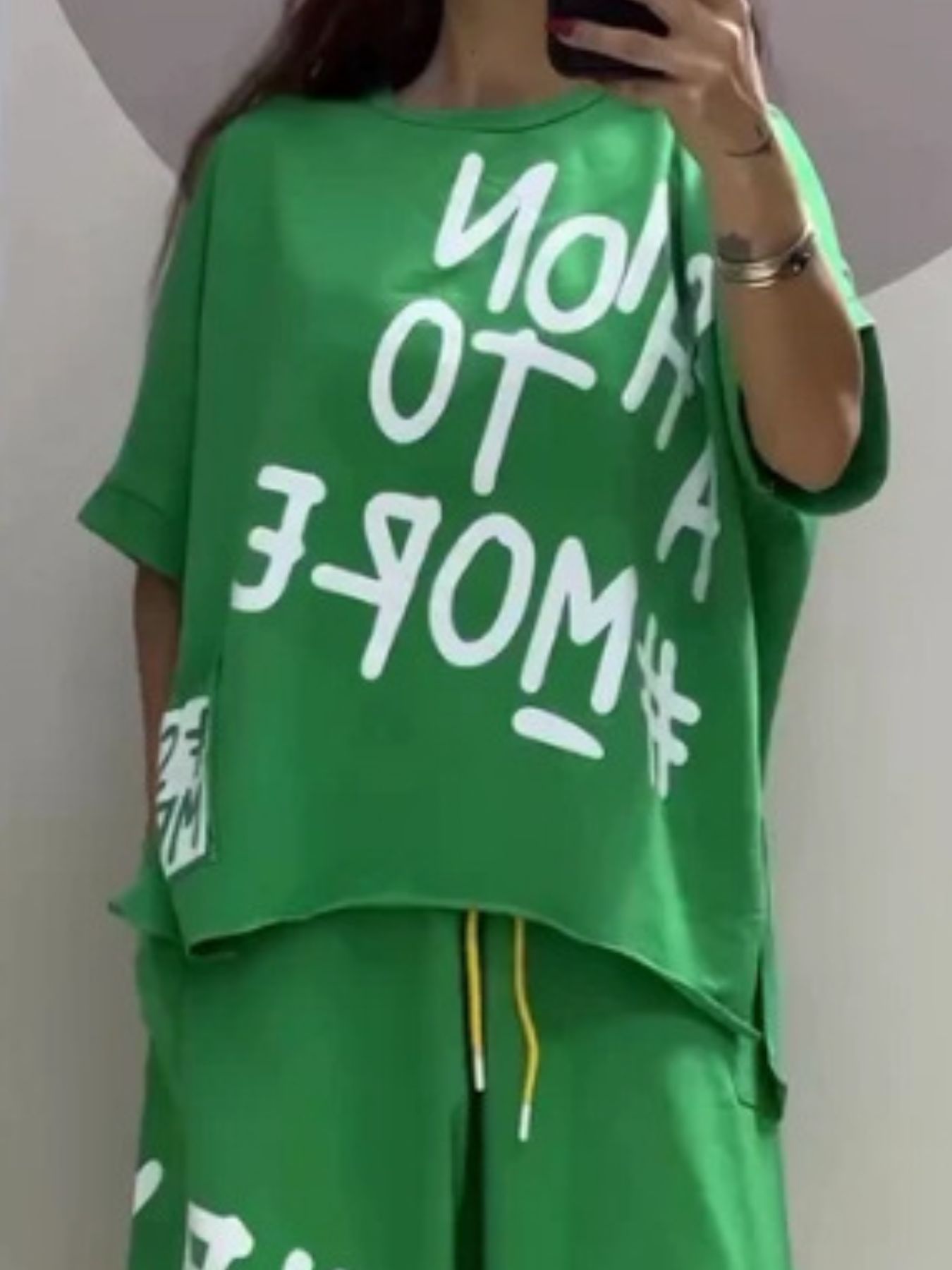 Green graphic tee with white text and drawstring pants set