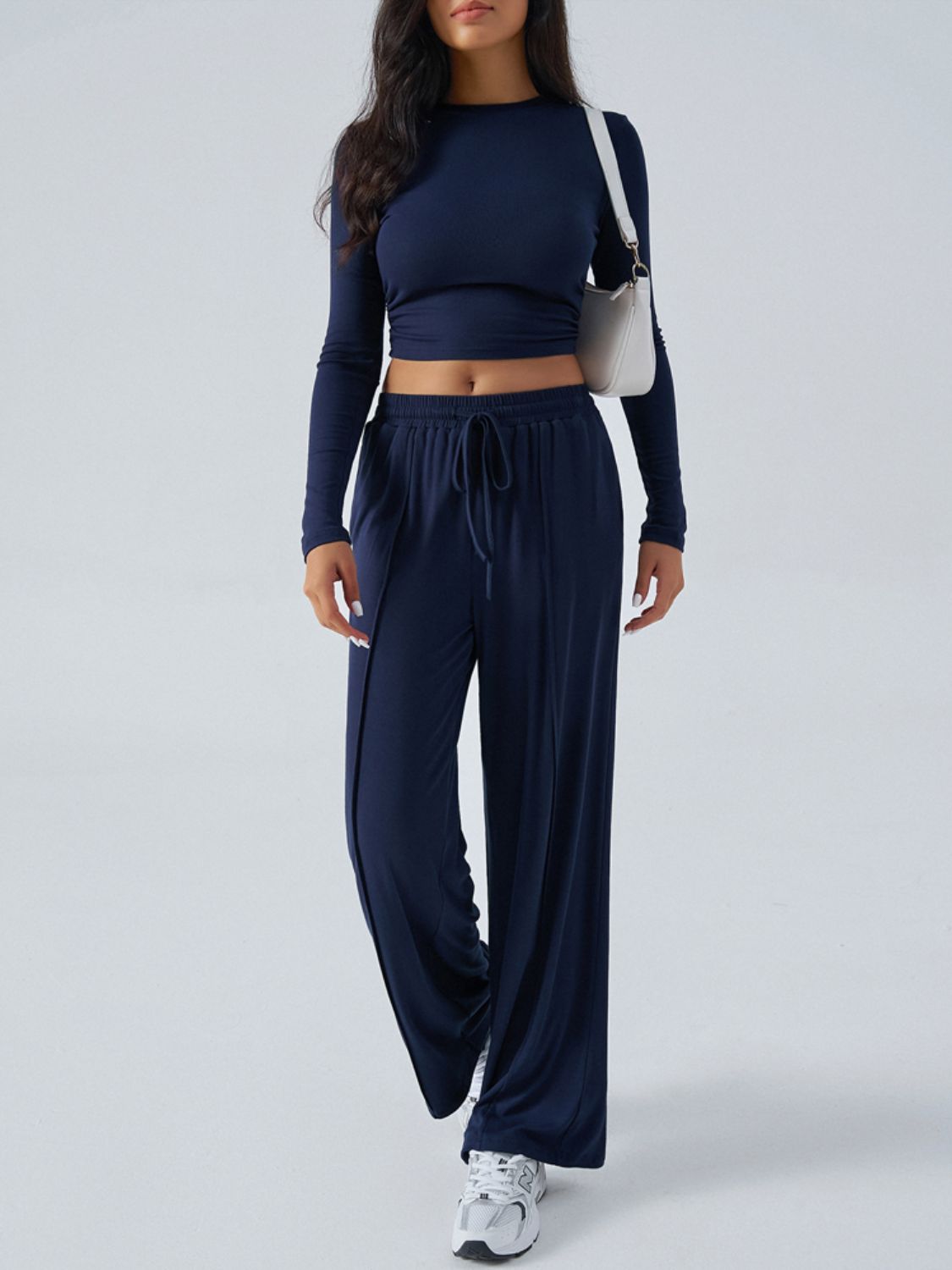 Dark blue ribbed knit crop top and wide leg pants set with drawstring waist.