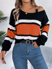 Asymmetric stripe knit sweater with shoulder detail, black, white, and orange stripes, acrylic.