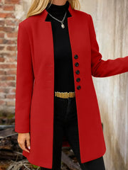 Scarlet longline trench coat with button-down front and collarless neckline.