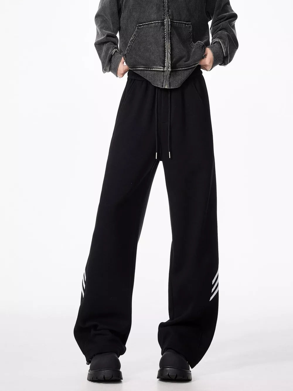 Black relaxed fit sweatpants with drawstring and white stripes on the leg