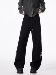 Black relaxed fit sweatpants with drawstring and white stripes on the leg