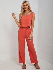Orange cropped tank top and palazzo pants set with square neckline and wide leg pants.