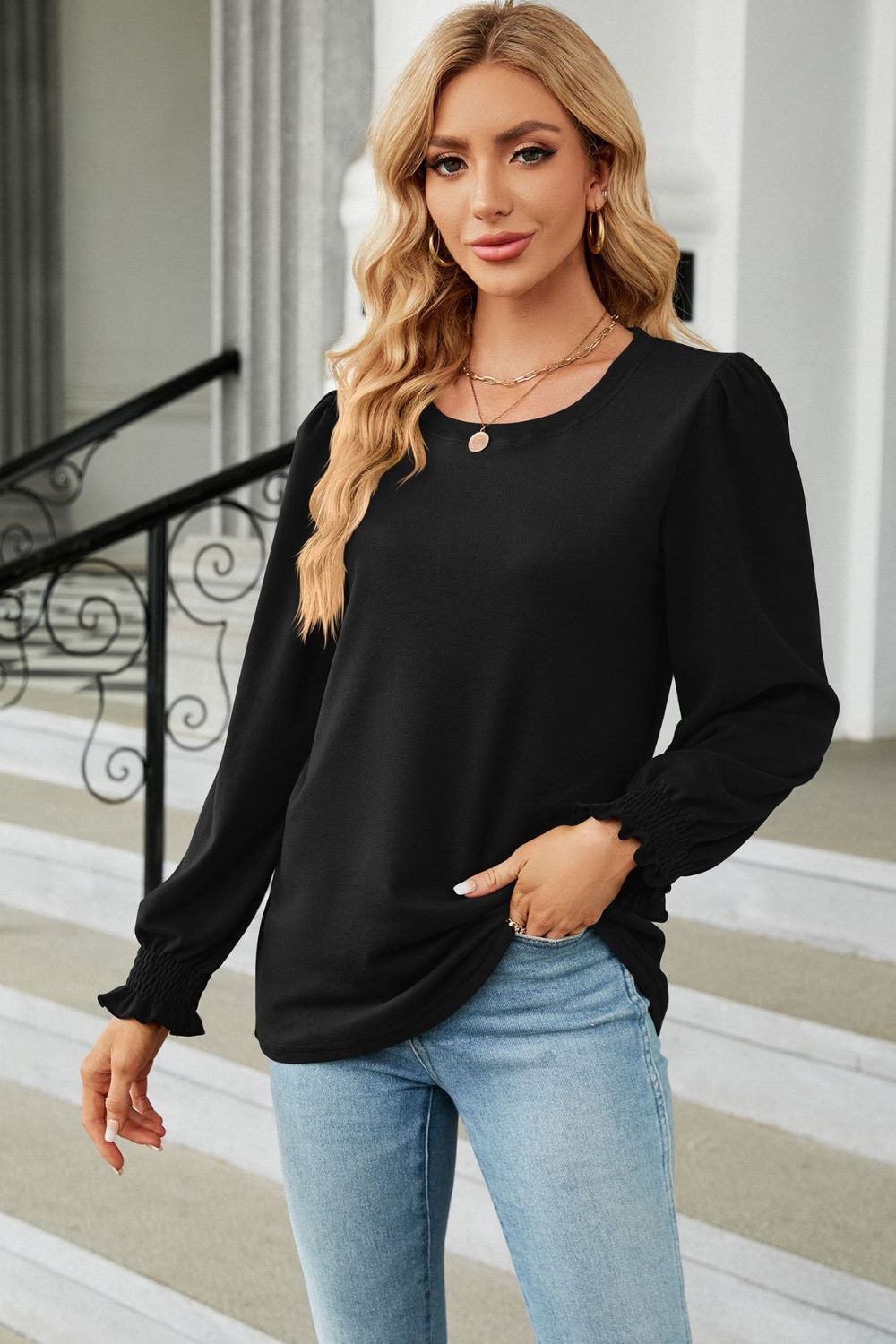 Black ribbed cuff top with puff sleeves and crew neckline.