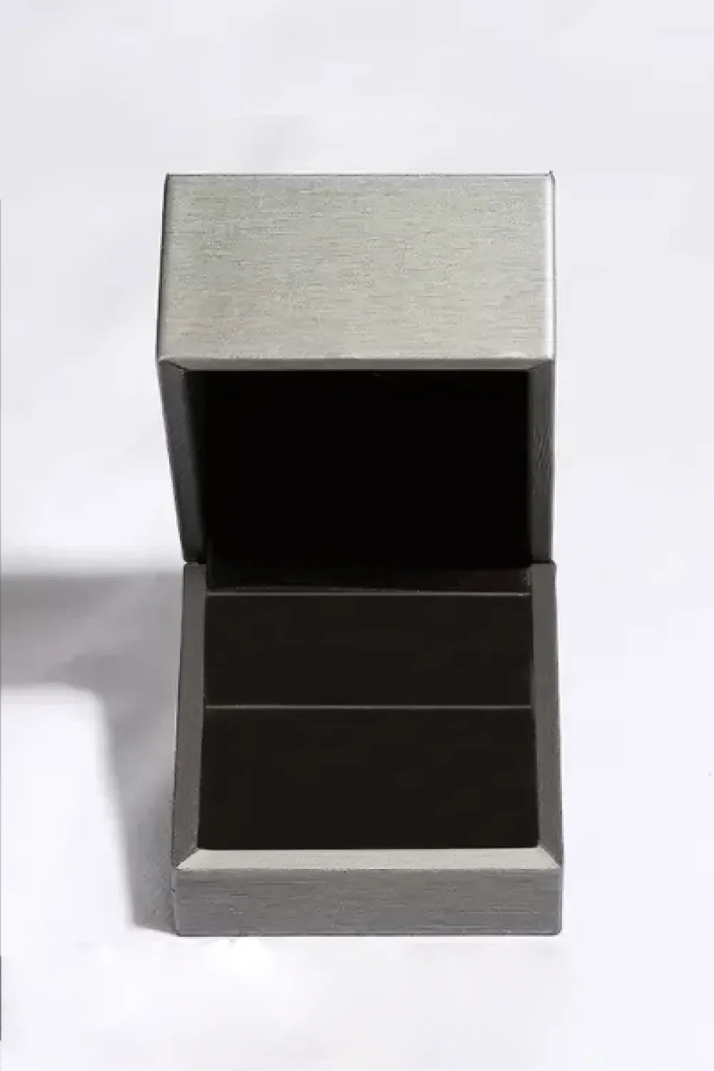 Silver ring box with open lid and black interior