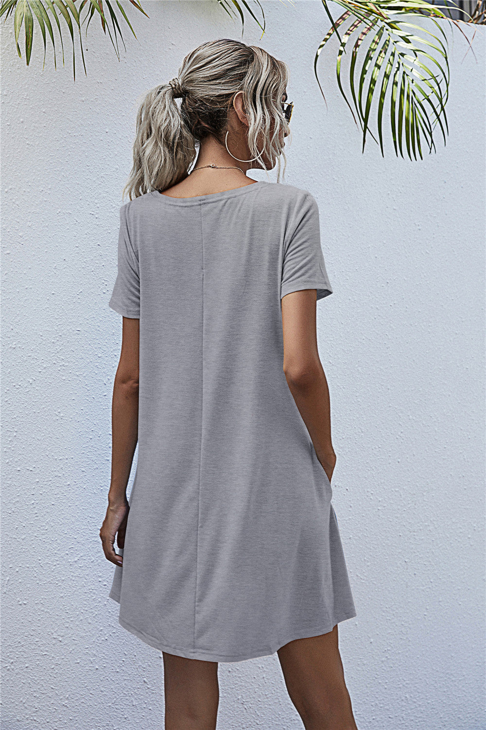 Light gray relaxed pocketed tee dress with short sleeves and crew neck.