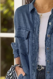 Oversized denim shirt jacket in light blue with buttoned front and chest pockets.