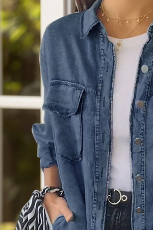 Oversized denim shirt jacket in light blue with buttoned front and chest pockets.