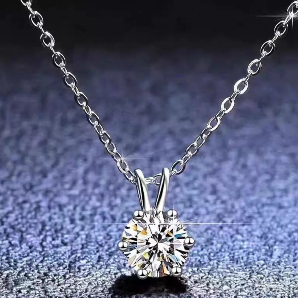 Elegant moissanite pendant necklace in sterling silver with a delicate chain.