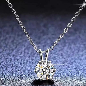 Elegant moissanite pendant necklace in sterling silver with a delicate chain.