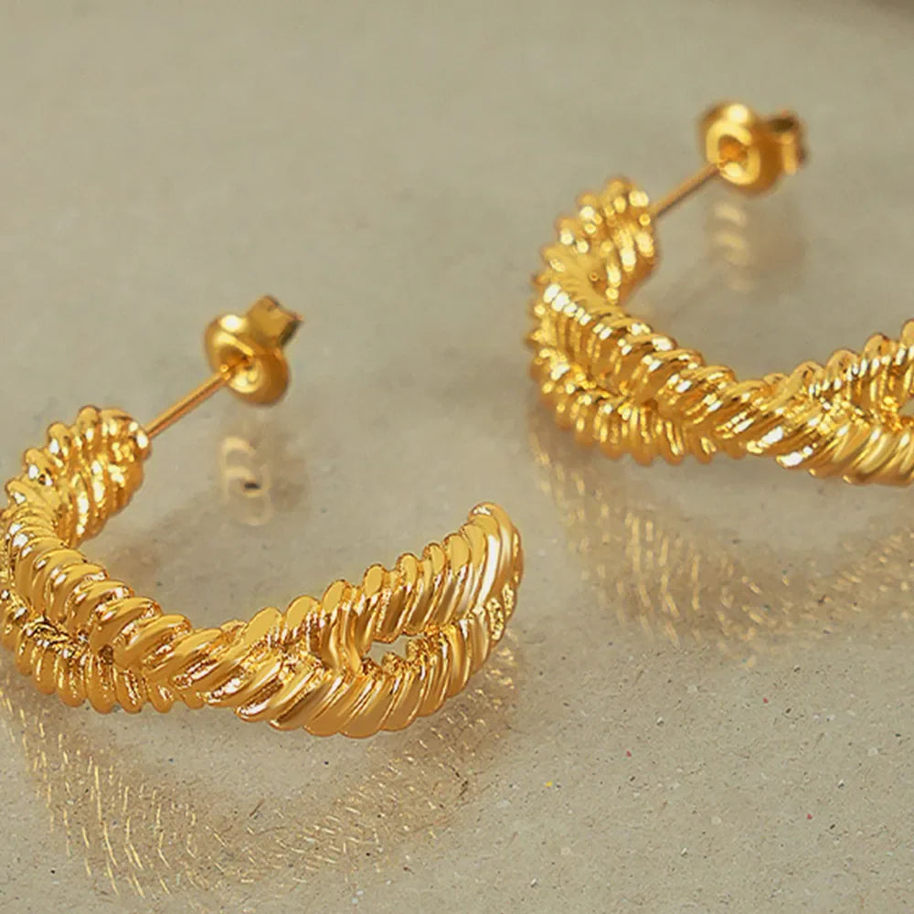 Gold vermeil braided hoop stud earrings with a textured design.