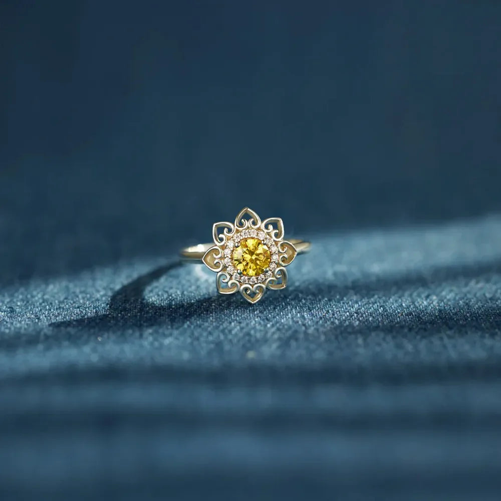 Floral filigree ring in silver with yellow center stone and clear accent stones
