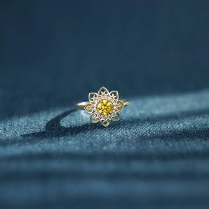 Floral filigree ring in silver with yellow center stone and clear accent stones