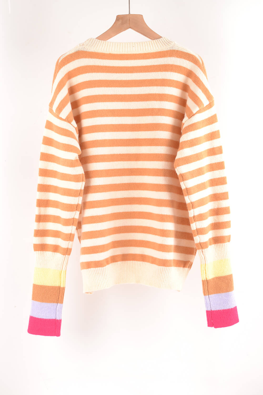 Acrylic sweater with orange and cream stripes and colorful striped cuffs.