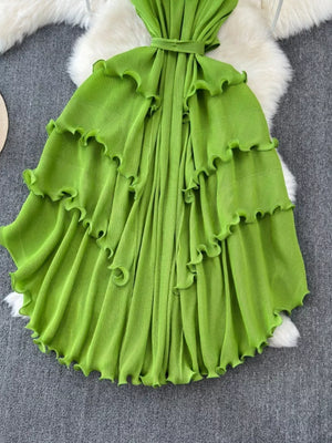 Lime green ruffled tiered midi dress with belted waist and frill details.