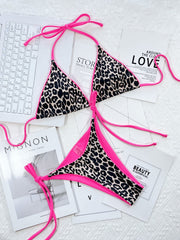 Leopard print tie-side bikini set with hot pink trim and ties.