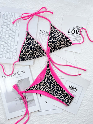 Leopard print tie-side bikini set with hot pink trim and ties.