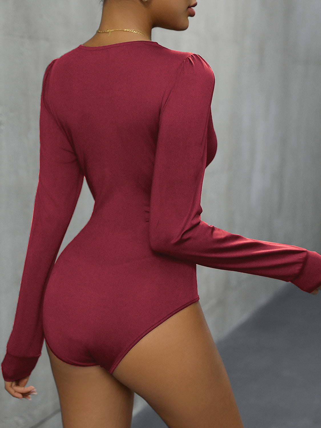 Burgundy long sleeve bodysuit with subtle shoulder ruching.