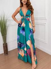 Teal floral maxi dress with plunging neckline, cutout sides, decorative ring, and thigh-high slit.