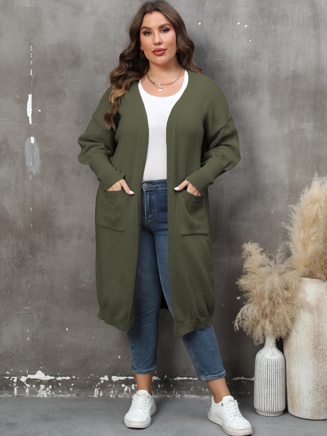 Oversized knit duster cardigan in army green with patch pockets and a relaxed fit.