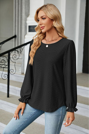 Black textured puff sleeve blouse with ruffle cuffs and round neckline.