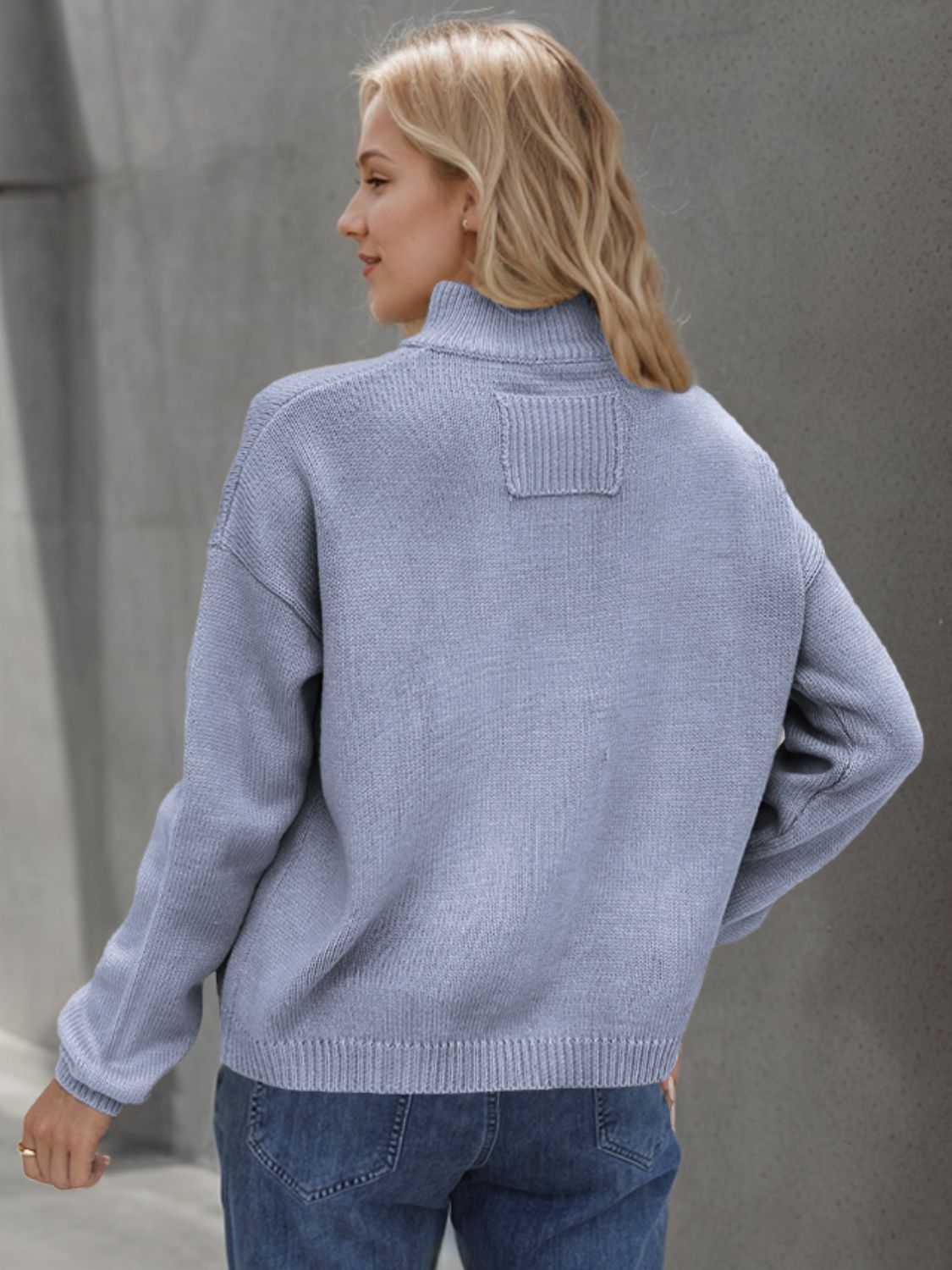 Light blue acrylic knit stand collar cardigan with ribbed details and a patch on the back.