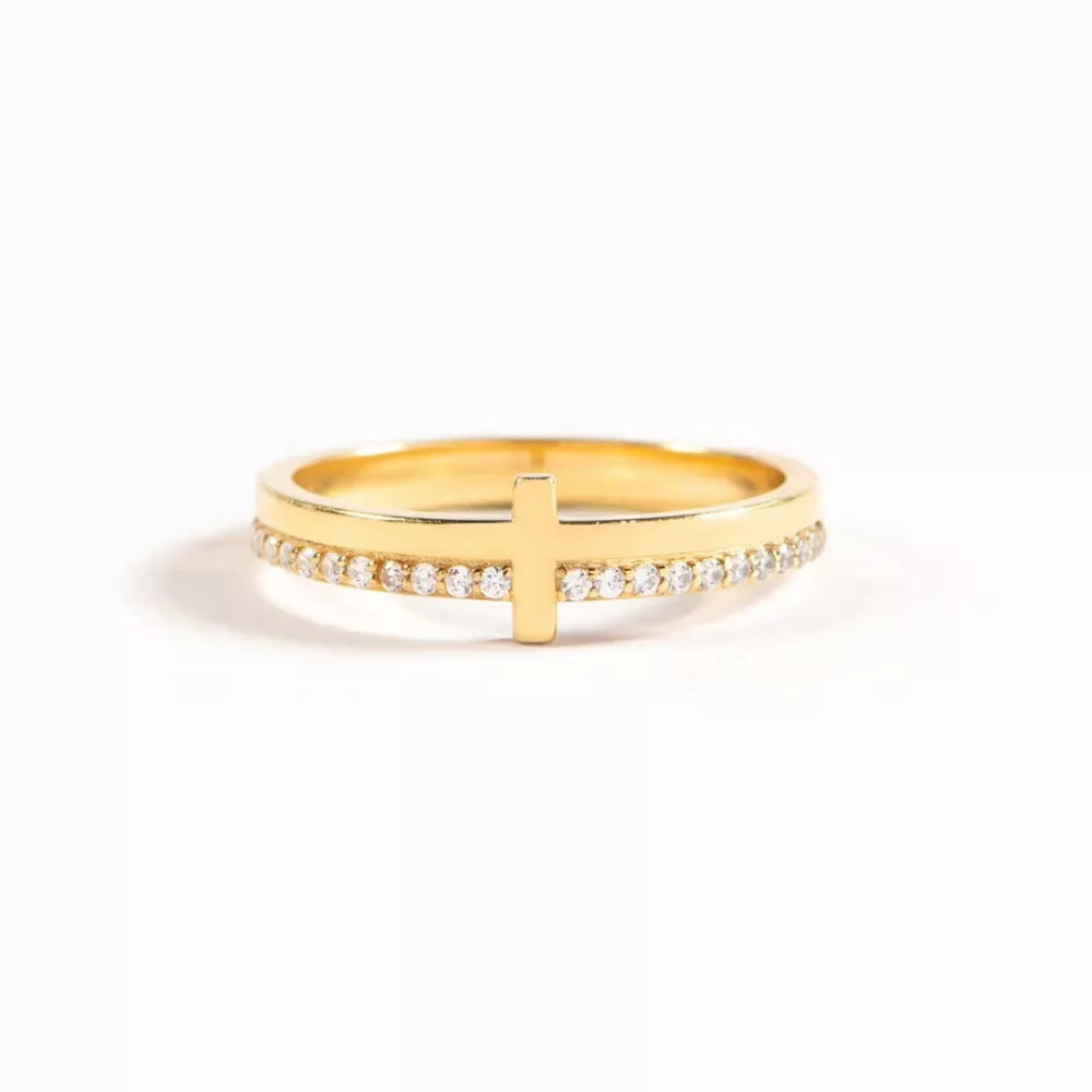 Gold-plated ring with a delicate cross and pave crystal band.
