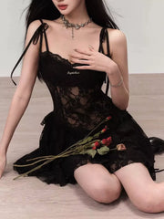Black lace tie-shoulder mini dress with sheer bodice and ruffled hem.