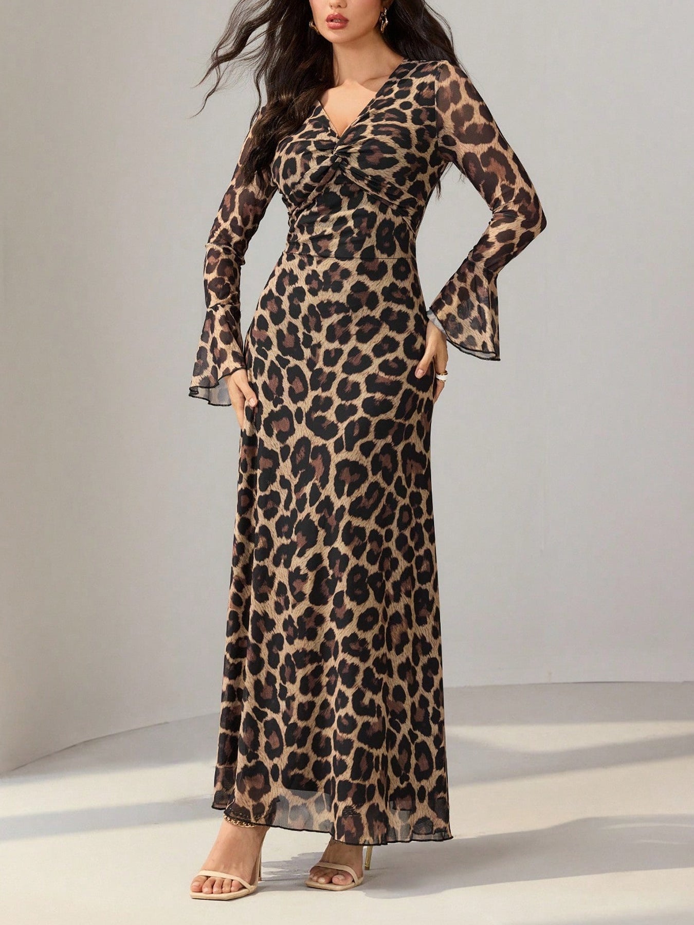 Maxi dress with animal print, V-neck, and flare sleeves.