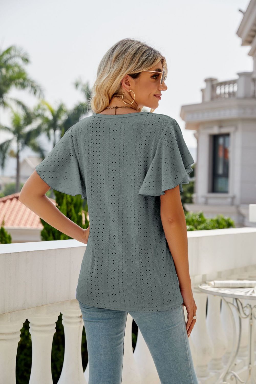 Sage eyelet flounce sleeve crew neck top with allover dot and diamond pattern.