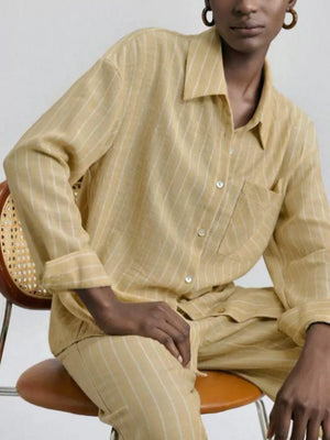 Chic yellow striped button-down shirt and pants set with pocket detail.
