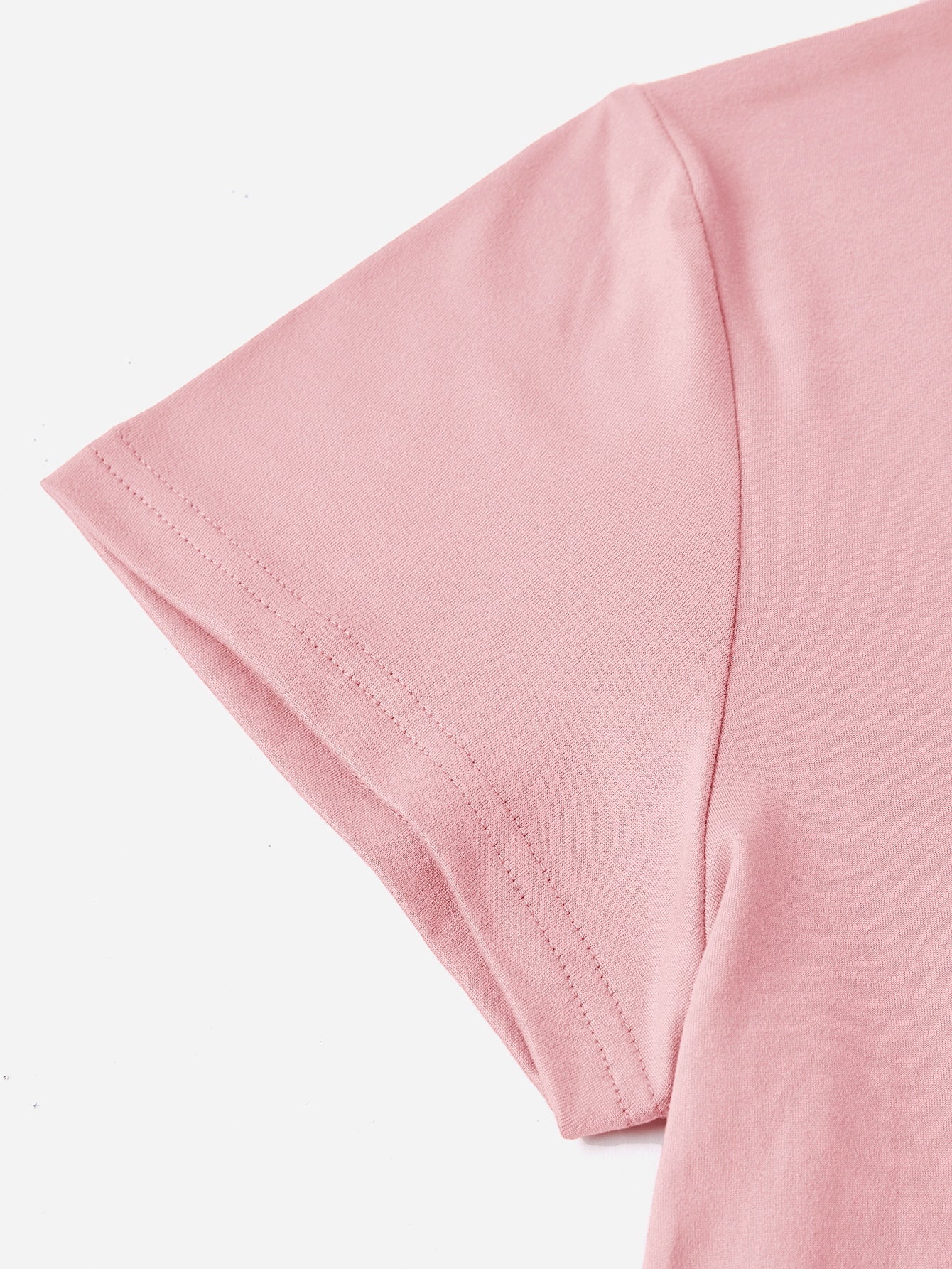Blush pink t-shirt with short sleeves and double-stitched hem.