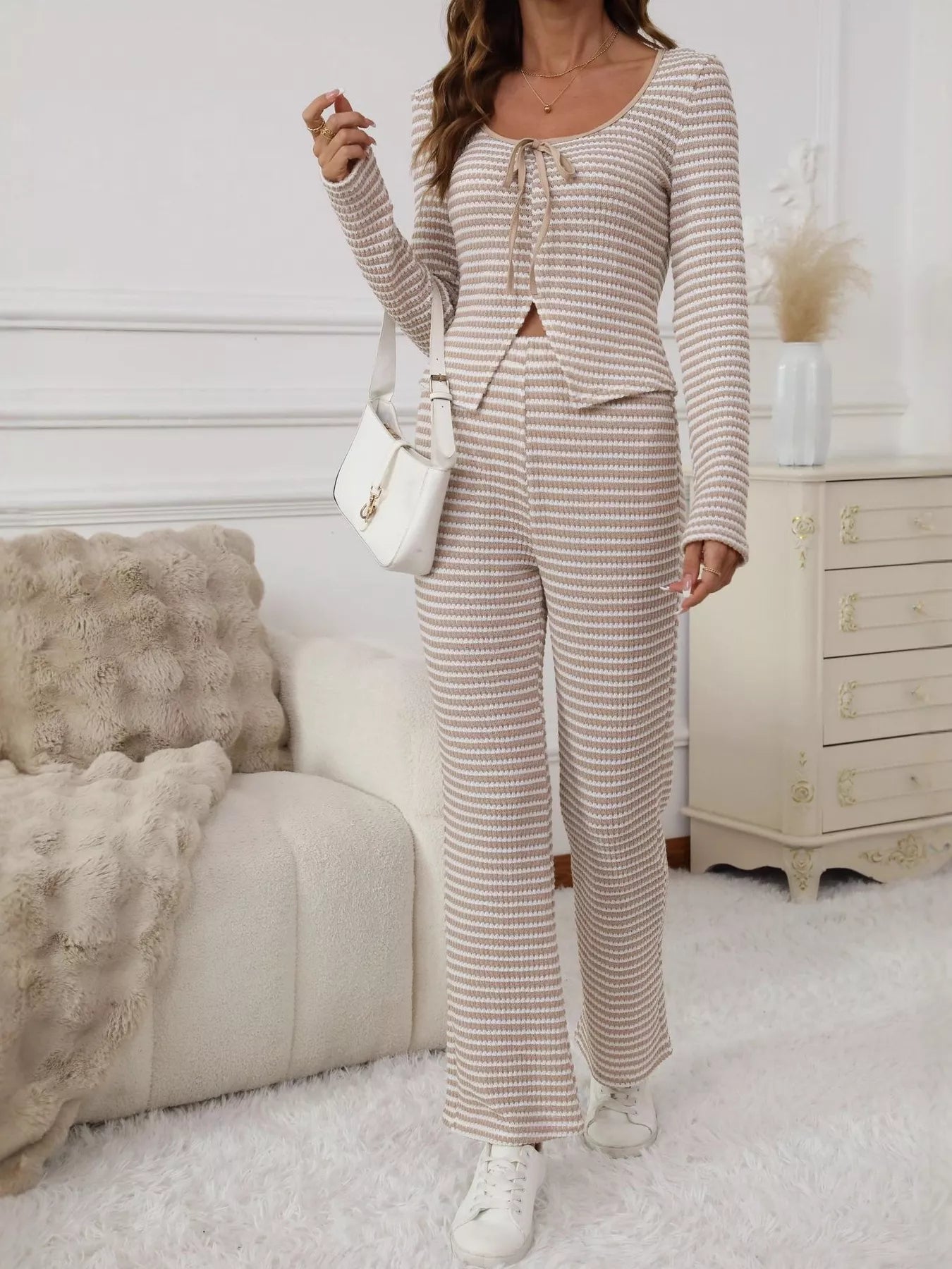 Tied two-piece apricot striped knit set with long sleeves and wide-leg pants.