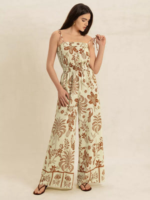 Tropical tie strap wide-leg romper in light green with brown floral and toucan print.