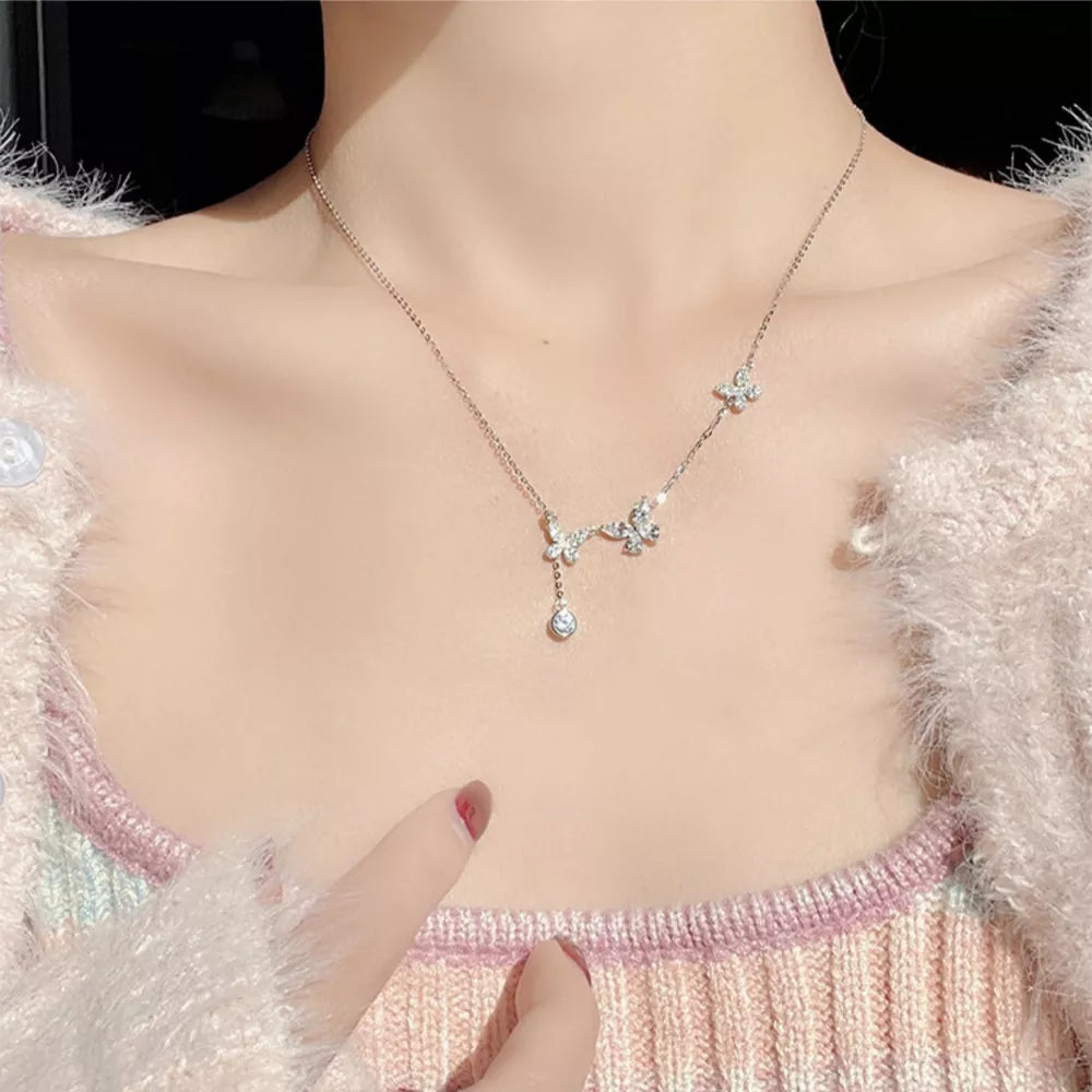 Elegant butterfly zircon necklace in silver with delicate charm and drop pendant.