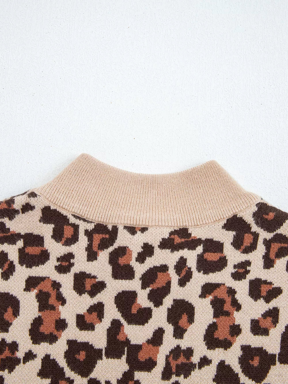 Leopard print ribbed high neck sweater dress with beige mock neck detail.