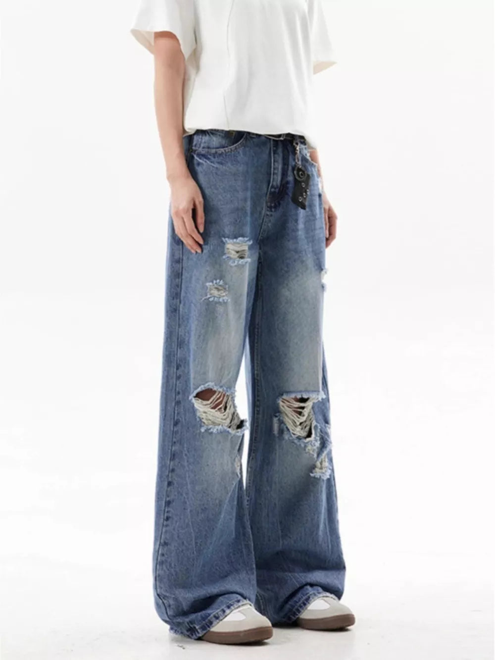 Men's distressed wide-leg jeans in blue denim with ripped details.