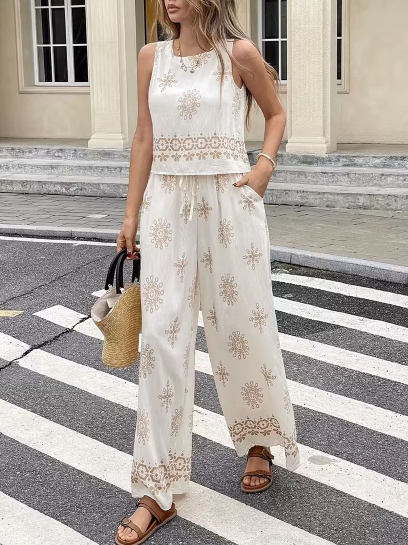 White two-piece set with medallion print, sleeveless top and wide-leg pants with drawstring waist.