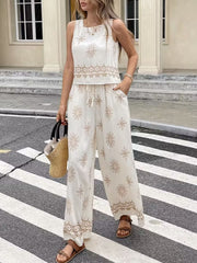 White two-piece set with medallion print, sleeveless top and wide-leg pants with drawstring waist.