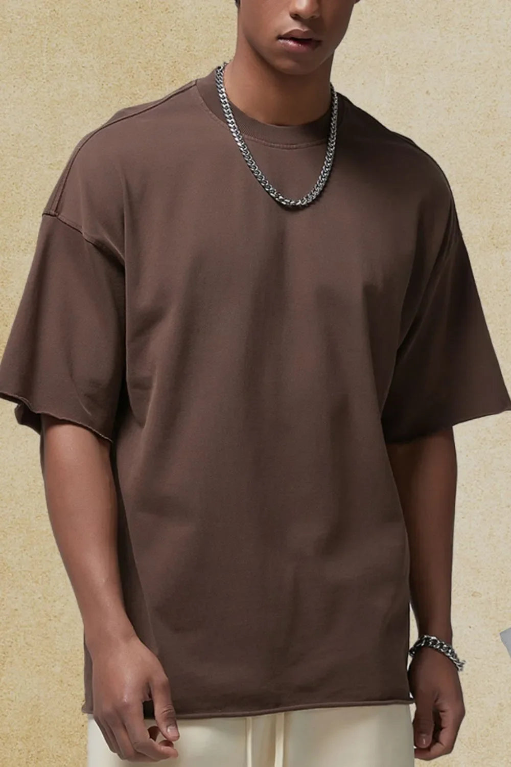 Coffee brown relaxed fit boxy tee with raw edges and short sleeves.