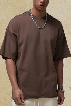 Coffee brown relaxed fit boxy tee with raw edges and short sleeves.