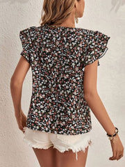 Black floral flutter sleeve blouse with a v-neckline and ruffled sleeves.