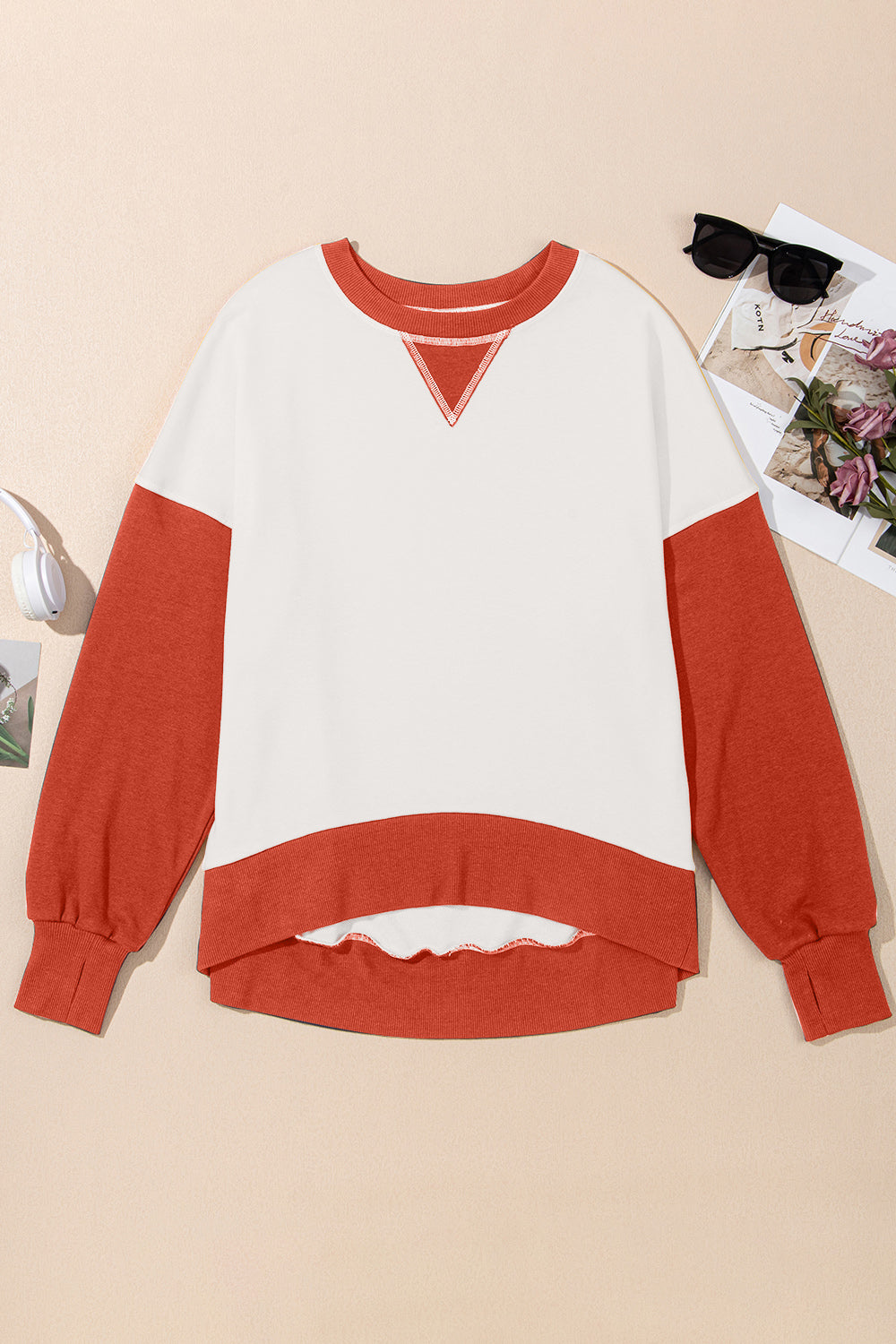 Chic Contrast Crewneck Sweatshirt in white with rust sleeves and hem, featuring a V-stitch detail.