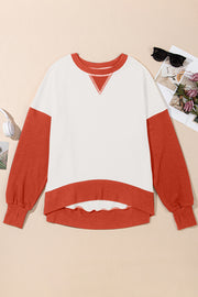 Chic Contrast Crewneck Sweatshirt in white with rust sleeves and hem, featuring a V-stitch detail.